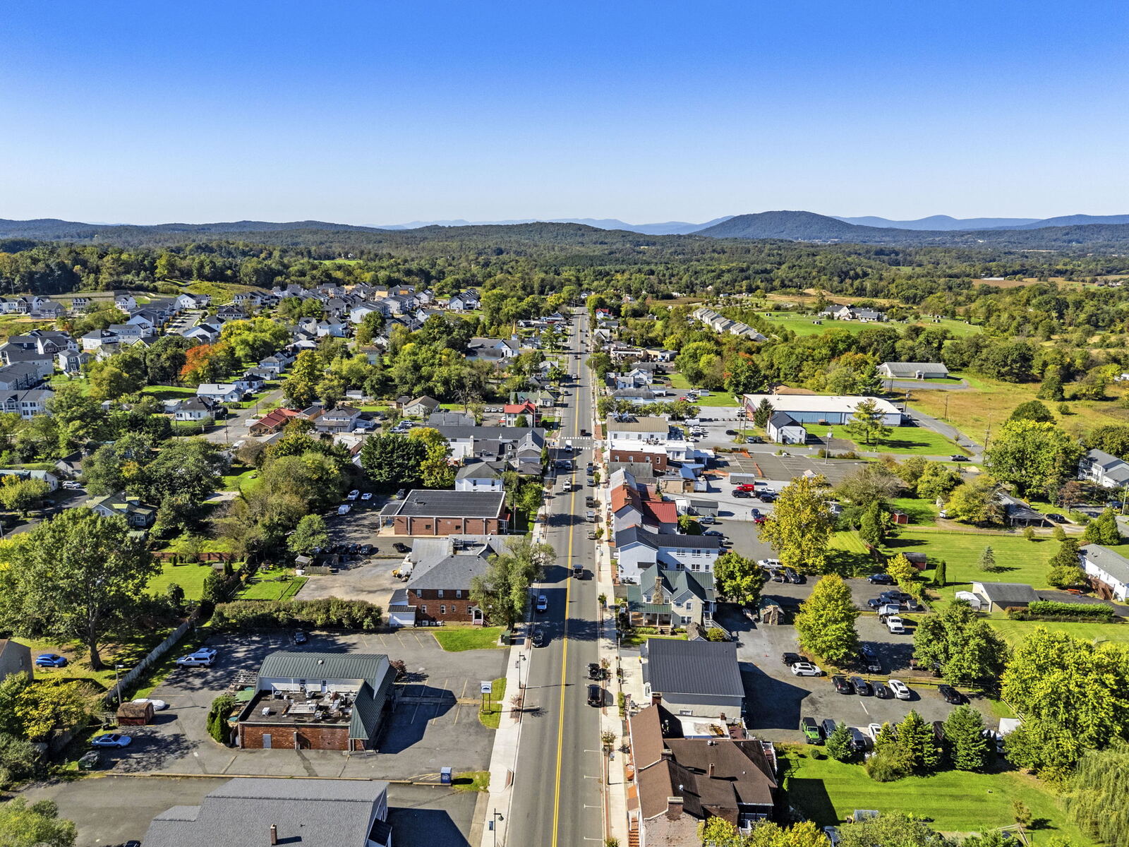 Aerial view looking down Main Street in Marshall toward distant hills and mountain peaks